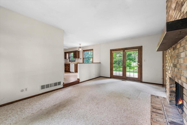 50 Southgate Crse, Saint Charles, IL 60174 - unfurnished living room featuring carpet, a brick fireplace, and baseboards
