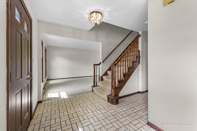 50 Southgate Crse, Saint Charles, IL 60174 - foyer featuring brick patterned floors, stairway, and baseboards