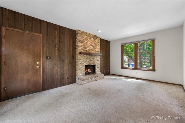 50 Southgate Crse, Saint Charles, IL 60174 - unfurnished living room featuring wood walls, carpet flooring, a brick fireplace, and baseboards