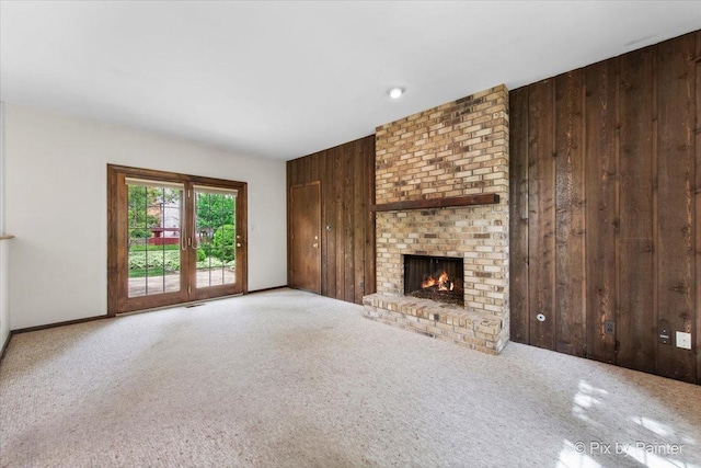 50 Southgate Crse, Saint Charles, IL 60174 - unfurnished living room with wood walls, a brick fireplace, carpet, and baseboards