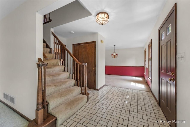 50 Southgate Crse, Saint Charles, IL 60174 - entryway with stairs, baseboards, a chandelier, and brick patterned floors