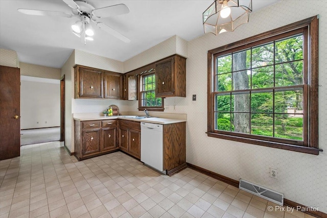 50 Southgate Crse, Saint Charles, IL 60174 - kitchen featuring white dishwasher, wallpapered walls, light countertops, a sink, and ceiling fan