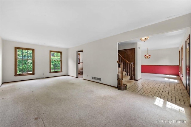 50 Southgate Crse, Saint Charles, IL 60174 - spare room featuring a chandelier, stairway, carpet floors, and baseboards