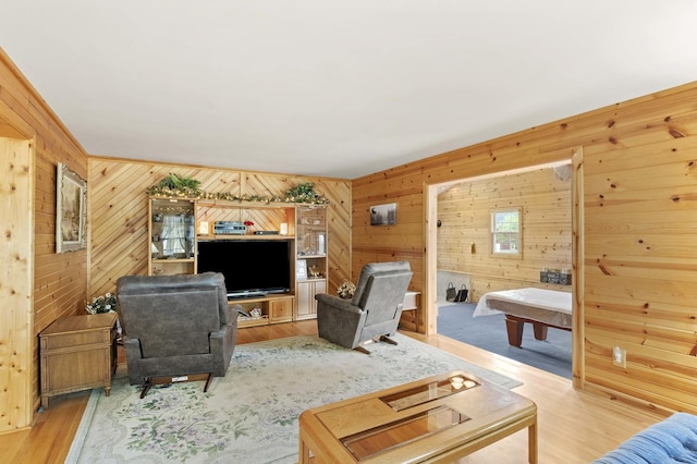 living room featuring wooden walls and wood finished floors