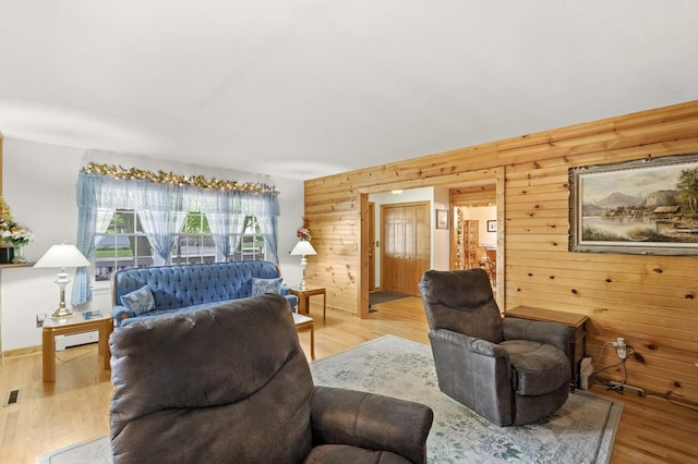 living room with wooden walls and wood finished floors