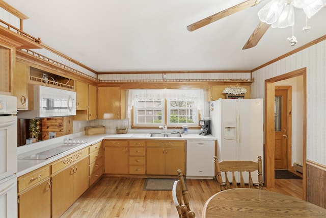 kitchen with white appliances, crown molding, wallpapered walls, light countertops, and light wood finished floors