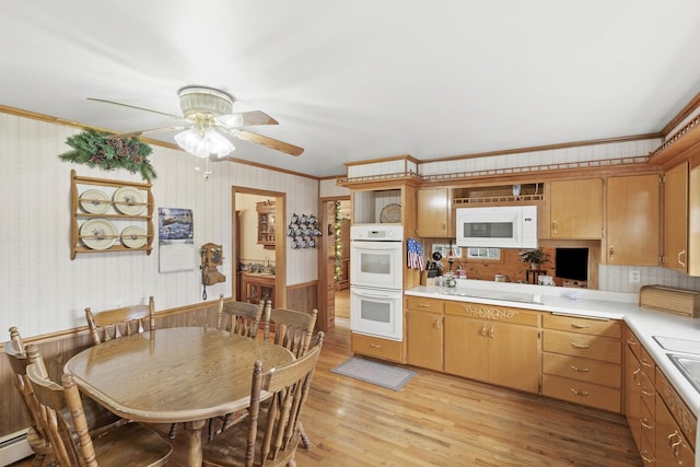 kitchen featuring white appliances, light countertops, crown molding, light wood-type flooring, and a ceiling fan