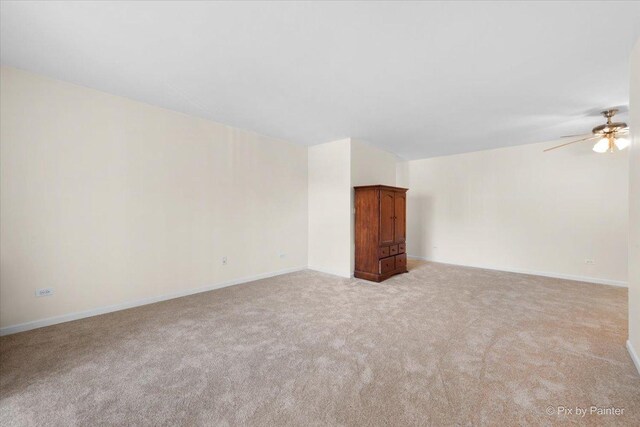 2221 W Nichols Rd Unit A, Arlington Heights, IL 60004 - empty room featuring light carpet, a ceiling fan, and baseboards