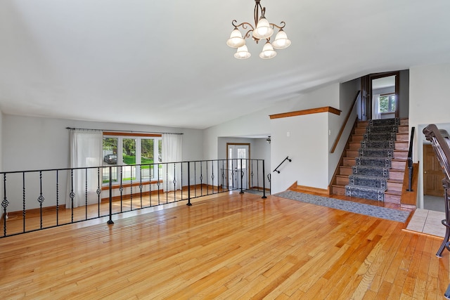 15325 Walnut Rd, Oak Forest, IL 60452 - unfurnished living room with wood-type flooring, a chandelier, and lofted ceiling