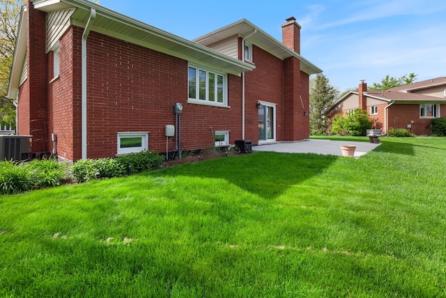 15325 Walnut Rd, Oak Forest, IL 60452 - back of property featuring a chimney, a patio, a lawn, central AC unit, and brick siding