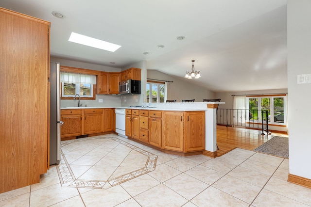 15325 Walnut Rd, Oak Forest, IL 60452 - kitchen featuring stainless steel appliances, a peninsula, a sink, light countertops, and a chandelier
