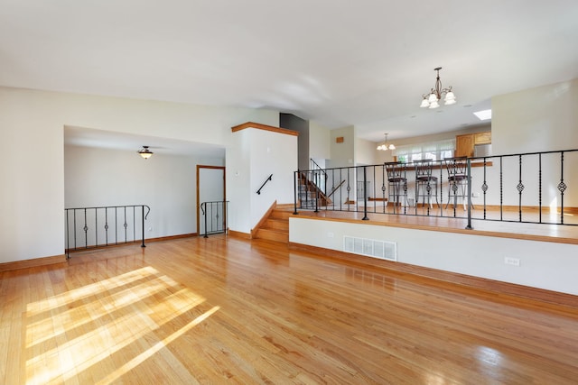 15325 Walnut Rd, Oak Forest, IL 60452 - spare room featuring a chandelier, light wood finished floors, baseboards, and stairs