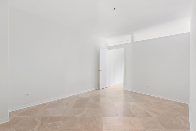 unfurnished room featuring baseboards