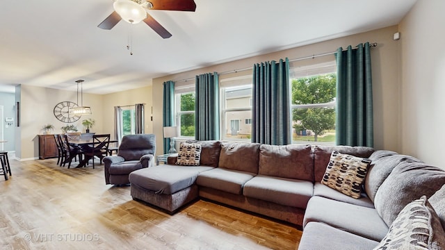 3756 Innesbrook Ct, Algonquin, IL 60102 - living area featuring light wood-style floors, healthy amount of natural light, a ceiling fan, and a chandelier