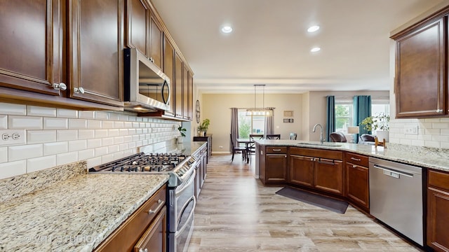 3756 Innesbrook Ct, Algonquin, IL 60102 - kitchen featuring stainless steel appliances, a sink, backsplash, a peninsula, and light wood-style floors