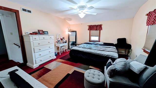 bedroom featuring ceiling fan and baseboards