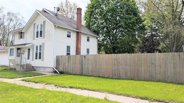 view of property exterior with a chimney and a garage