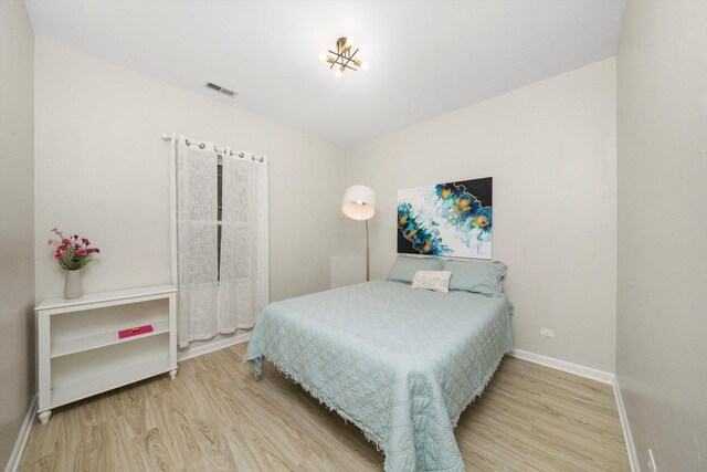 bedroom featuring wood finished floors and baseboards