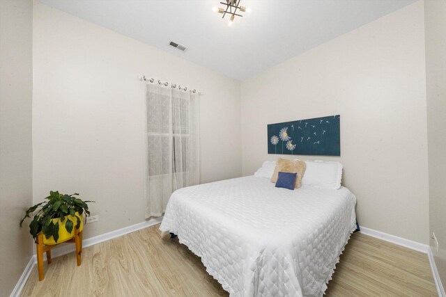 bedroom featuring wood finished floors and baseboards