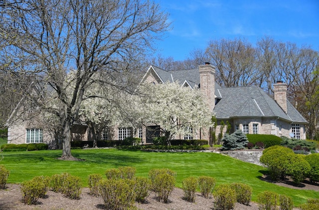 4N749 Old Farm Rd, Saint Charles, IL 60175 - view of front of house with a chimney, a front yard, and stone siding