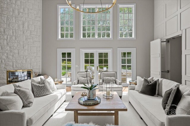 4N749 Old Farm Rd, Saint Charles, IL 60175 - living room featuring a towering ceiling, a chandelier, french doors, and a fireplace