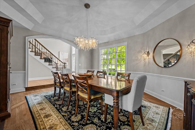 4N749 Old Farm Rd, Saint Charles, IL 60175 - dining space with arched walkways, a chandelier, a raised ceiling, stairway, and wood finished floors