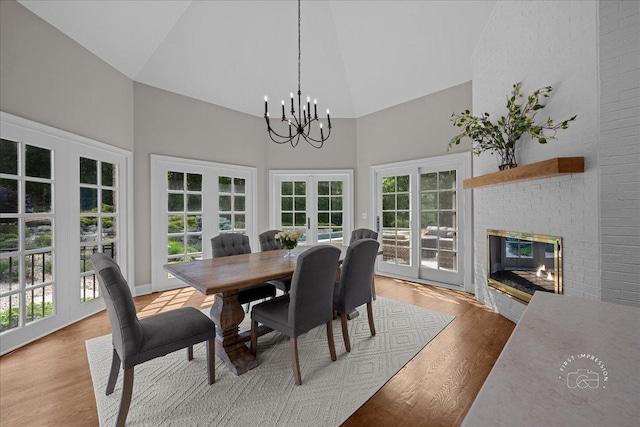 4N749 Old Farm Rd, Saint Charles, IL 60175 - dining area featuring french doors, high vaulted ceiling, a chandelier, light wood finished floors, and a fireplace