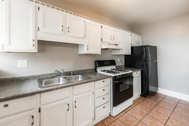 kitchen with range with gas stovetop, a sink, under cabinet range hood, freestanding refrigerator, and white cabinetry
