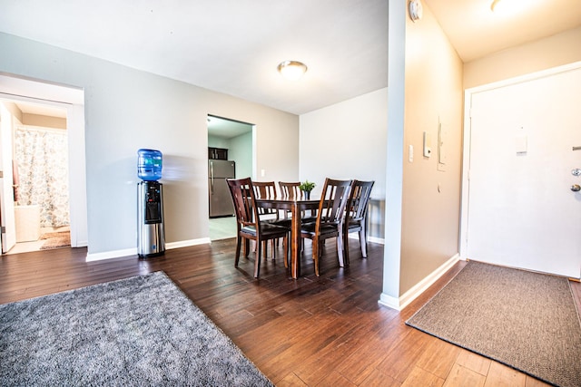 dining room featuring wood finished floors and baseboards