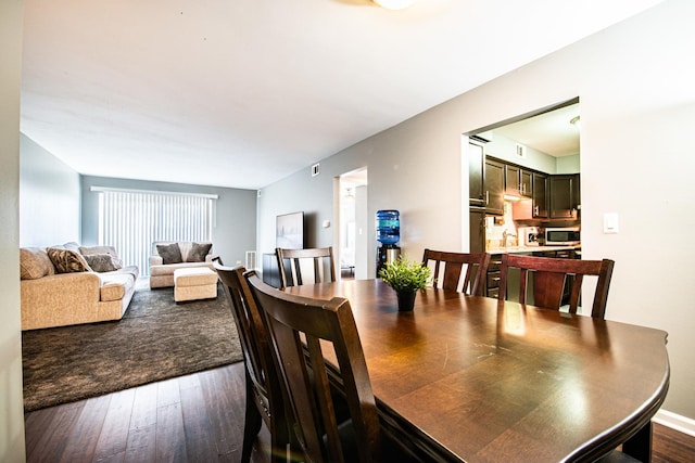 dining area featuring dark wood-type flooring