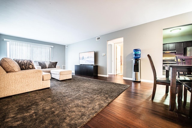 living area featuring dark wood finished floors and baseboards