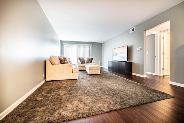 living area featuring dark wood finished floors and baseboards