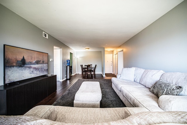 living area with dark wood-style floors and baseboards