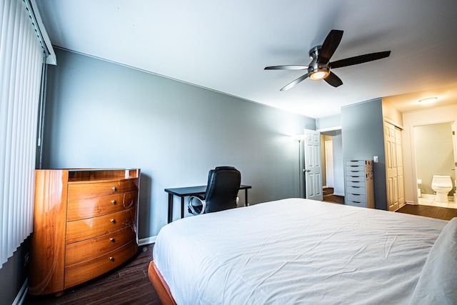 bedroom featuring dark wood-style flooring, baseboards, connected bathroom, and a ceiling fan