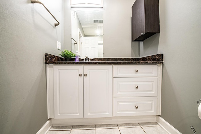 bathroom with tile patterned floors, vanity, and baseboards