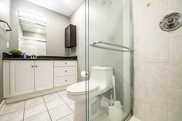 full bathroom with a stall shower, tile patterned floors, toilet, and vanity