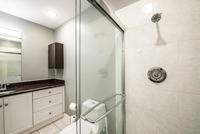 full bathroom with a stall shower, tile patterned flooring, vanity, and toilet