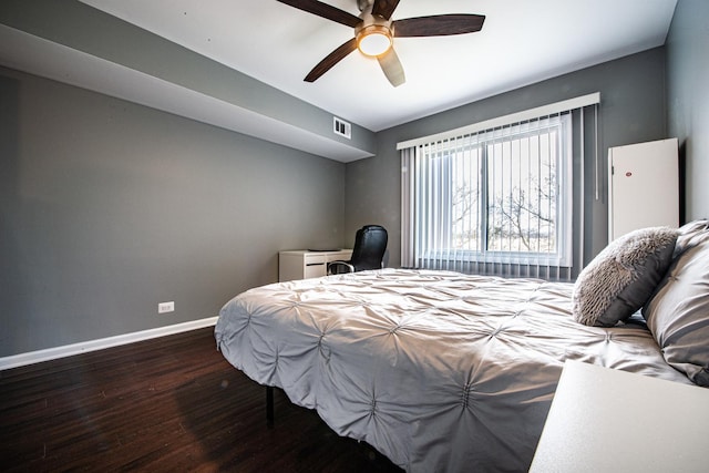 bedroom featuring wood finished floors, baseboards, and a ceiling fan