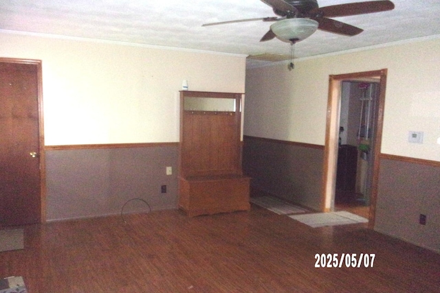 704 E Sycamore St, Watseka, IL 60970 - empty room with a wainscoted wall, ornamental molding, a ceiling fan, and wood finished floors