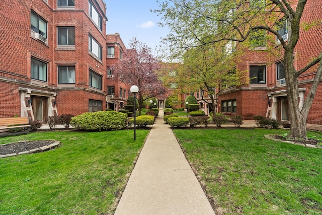 view of property's community with a lawn