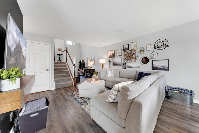 living room with stairs, wood finished floors, and baseboards