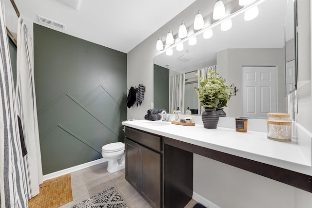 bathroom featuring toilet, vanity, and tile patterned floors