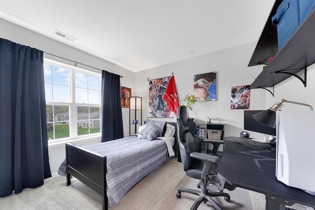bedroom with carpet flooring and an office area