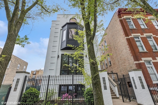 view of building exterior featuring a fenced front yard