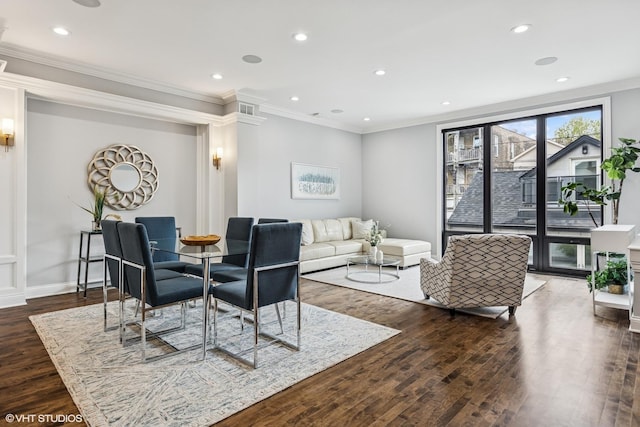 living area with wood finished floors, crown molding, recessed lighting, and baseboards