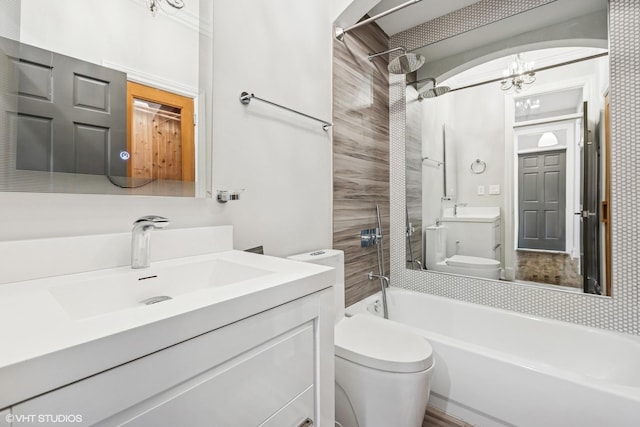 full bath featuring toilet, washtub / shower combination, and vanity