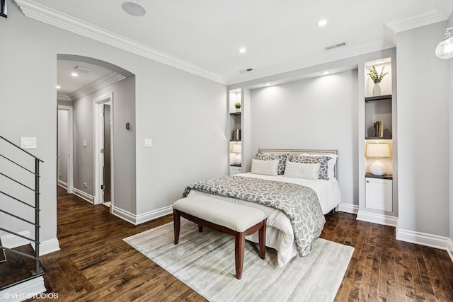 bedroom with arched walkways, wood finished floors, crown molding, recessed lighting, and baseboards