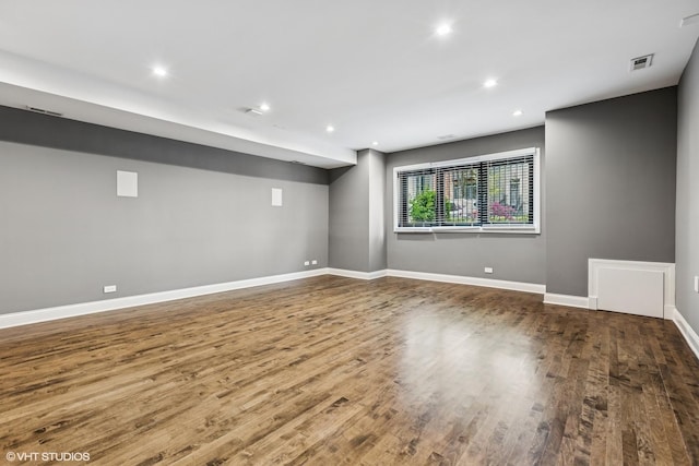 basement with wood finished floors, baseboards, and recessed lighting
