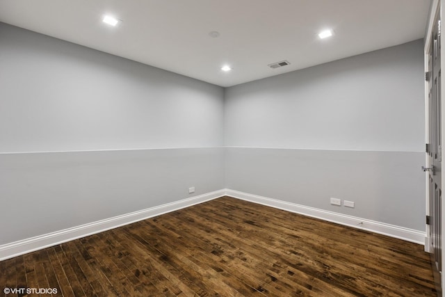unfurnished room featuring baseboards, dark wood finished floors, and recessed lighting