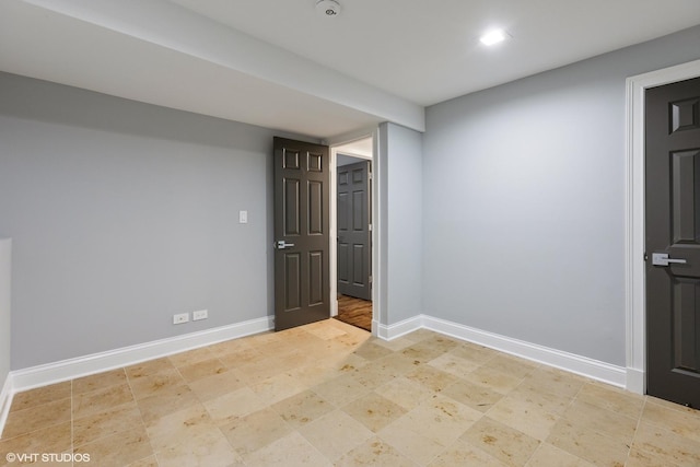 spare room featuring baseboards and recessed lighting